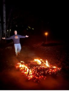 man preparing to walk over burning coals