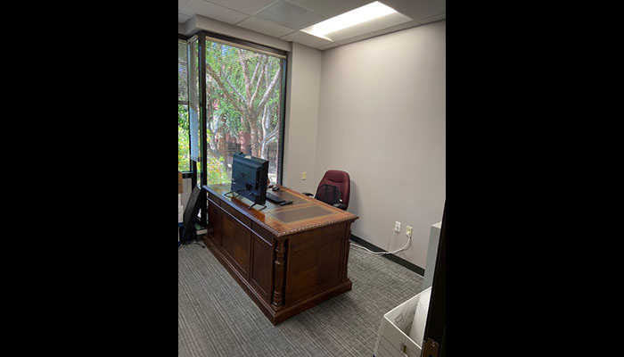 desk in private office with large window