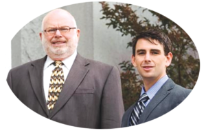 Contra Costa County attorneys Merritt and Ethan Weisinger, standing together in suits.