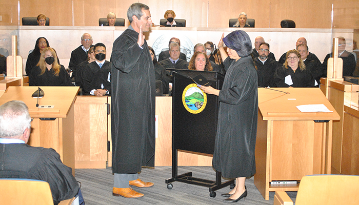Judge Kirk Athanasiou takes the oath of office, administered by Judge Joni Hiramoto as the bench of the Contra Costa County Superior Court sits en banc.