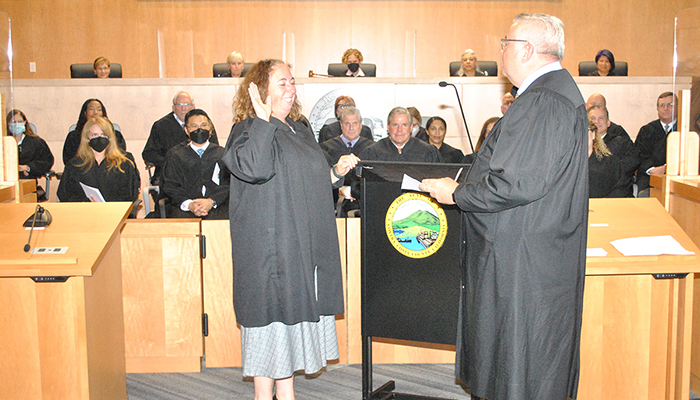 Judge Jennifer Lee takes her oath of office at her induction ceremony on June 3, 2022.