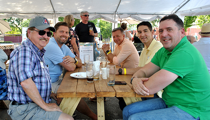 Five men sit at outdoor picnic table at the CCCBA's all section summer mixer in Walnut Creek on June 8.