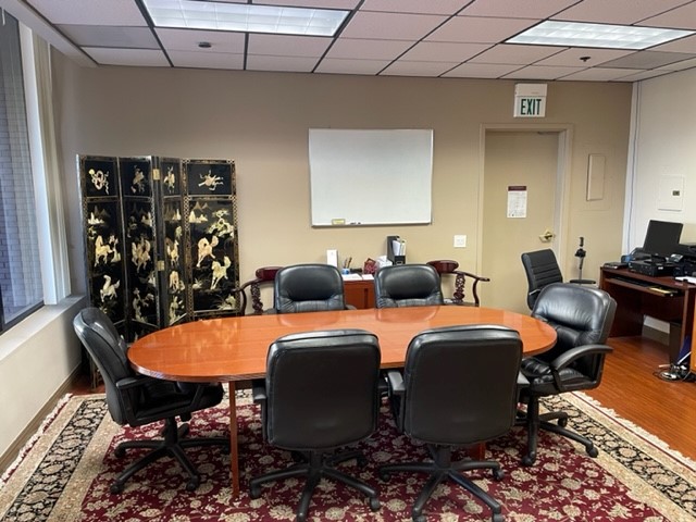 conference room with large table, 6 chairs and white board