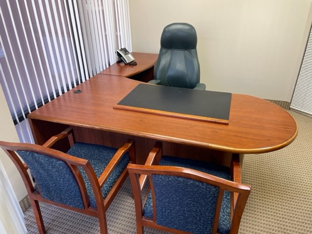 large desk with two guest chairs