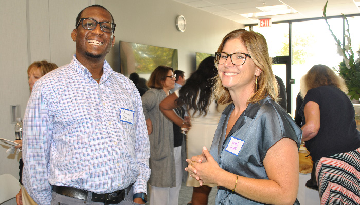 Man and women smiling at cocktail party