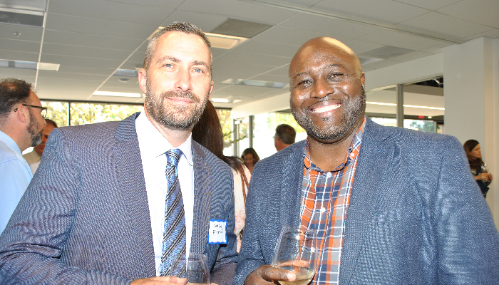 Two men smiling