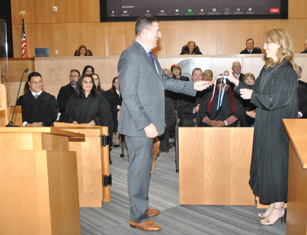 David Pearson, Treasurer of the Contra Costa County Bar Association presents the gavel to newly inducted Judge Colleen Gleason on October 14, 2022.