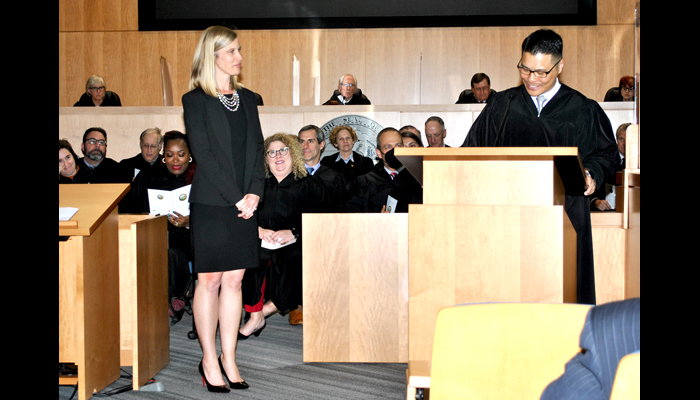 Judge Shara Beltramo stands near Judge Glenn Kim at the poedium at her judicial induction ceremony March 30.