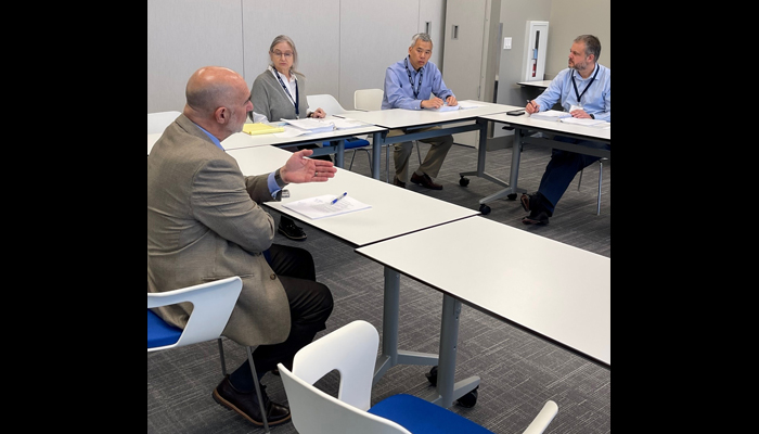 Group of attorneys discussing trial strategy in a conference room.