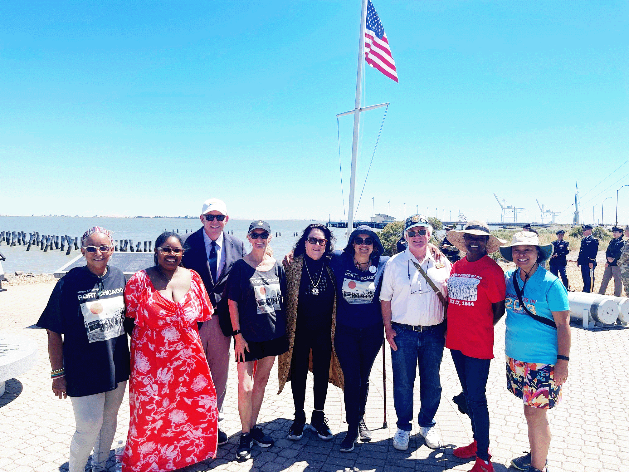 group photo of 10 attendees in front of US flag at the 79th annual commemoration of the Port Chicago Disaster on July 15, 2023.