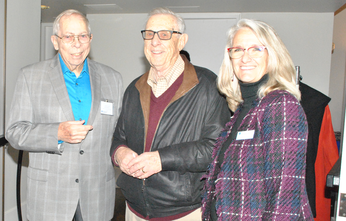 Two men and woman smiling