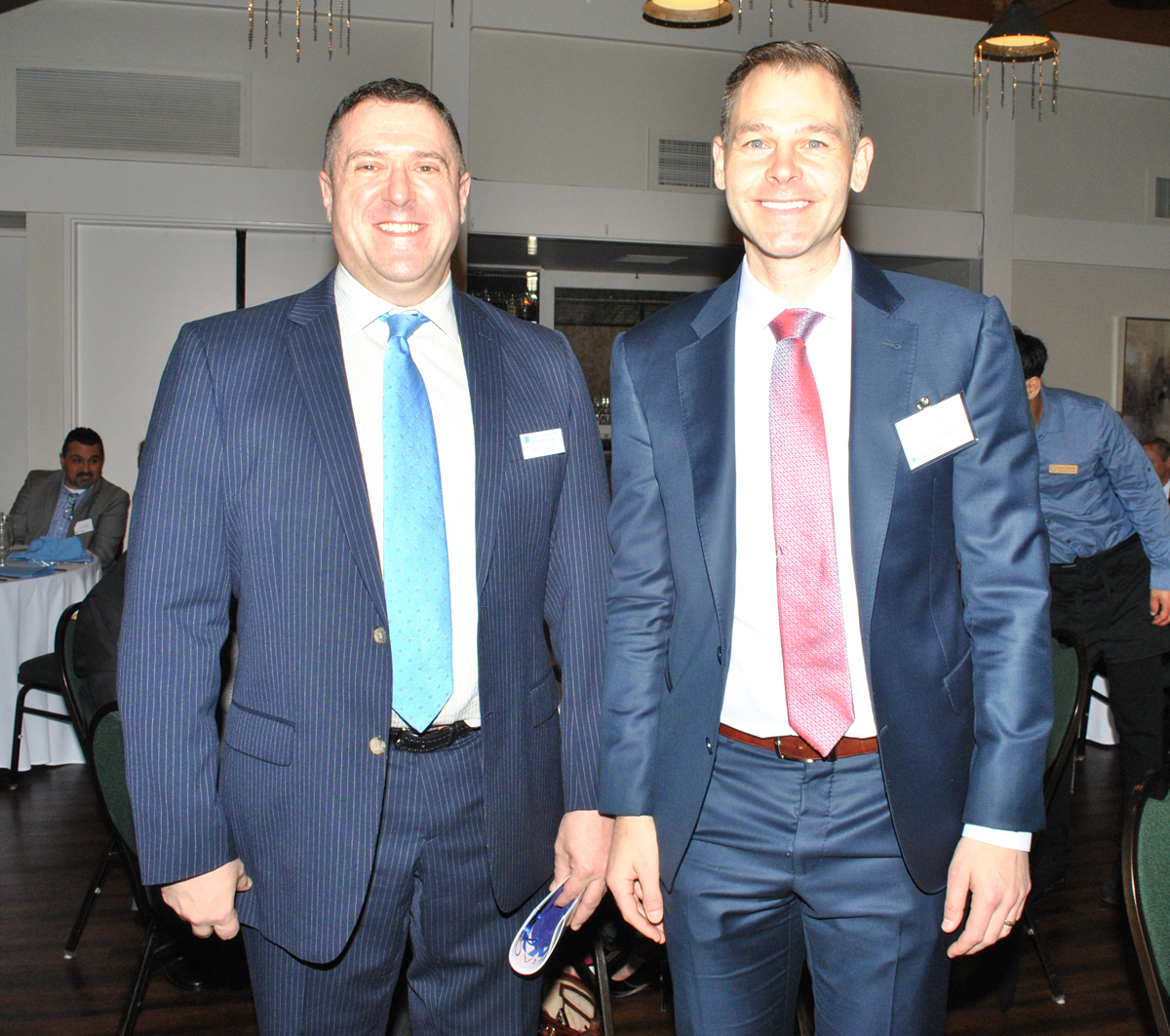 Two men smiling