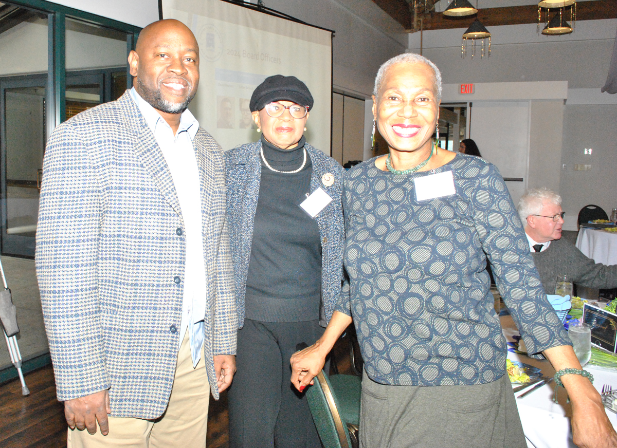 Three people smiling
