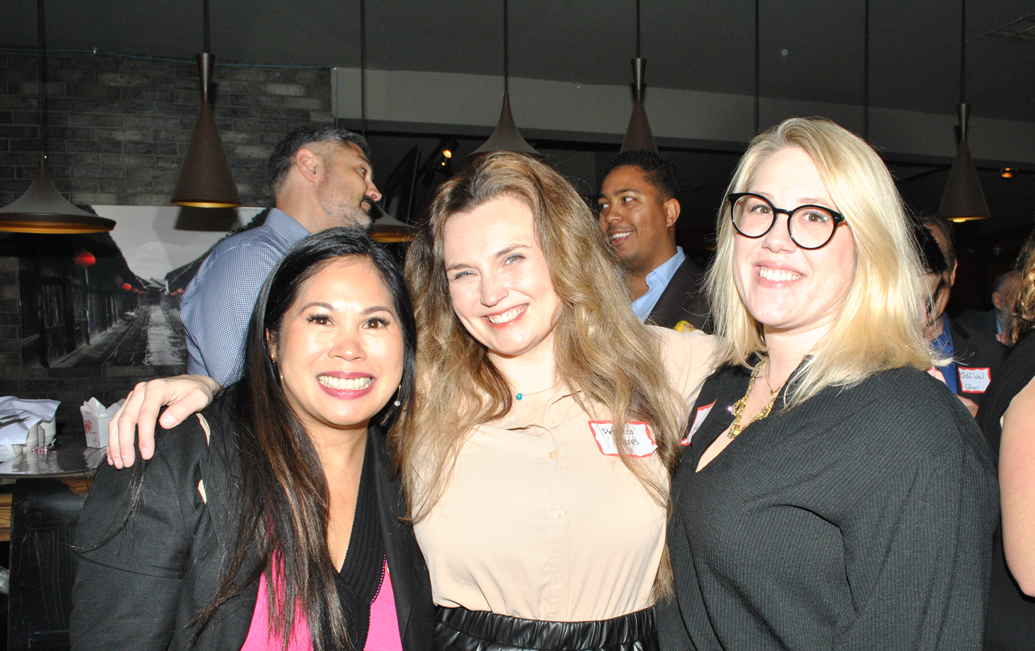 Three women smiling