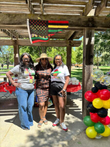 Three women outdoors for Juneteenth celebration at Pleasant Hill Park.